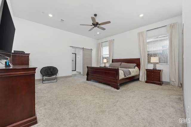 bedroom with a barn door, recessed lighting, light carpet, visible vents, and a ceiling fan