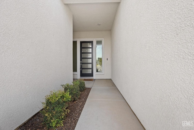 doorway to property with stucco siding