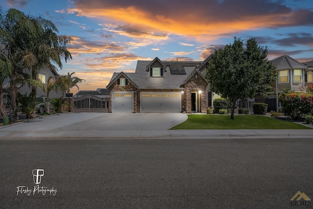 view of front of property with a yard and solar panels