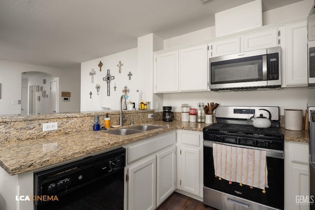 10006 Grand View Summit Dr, Bakersfield, CA 93311 - kitchen featuring stainless steel appliances, a peninsula, white cabinets, light stone countertops, and arched walkways