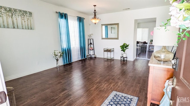 interior space featuring wood finished floors, baseboards, and visible vents