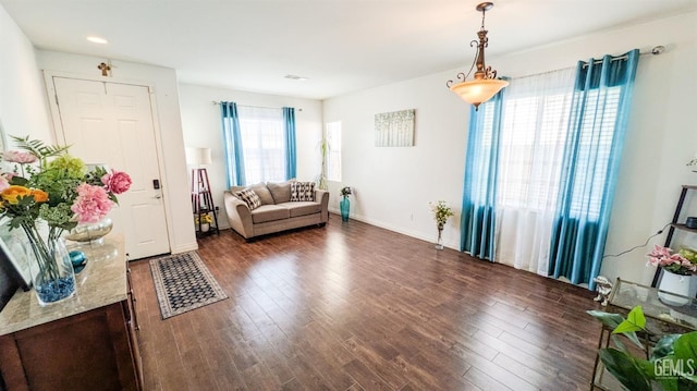interior space with dark wood-style flooring and baseboards