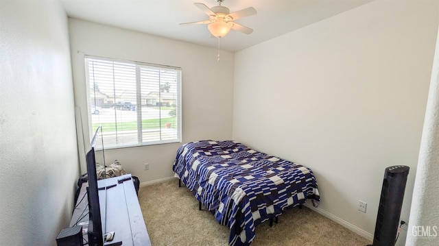 carpeted bedroom with baseboards and a ceiling fan