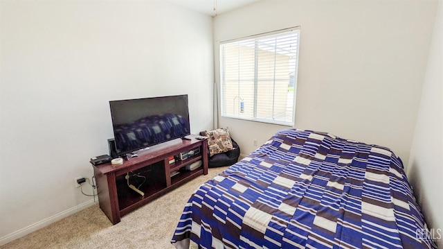 carpeted bedroom featuring baseboards