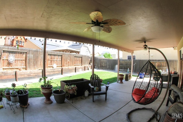 view of patio with a fenced backyard and a ceiling fan