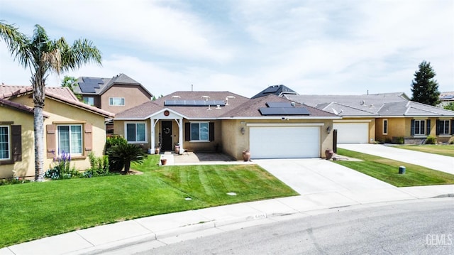 view of front of home with roof mounted solar panels, a garage, stucco siding, a front lawn, and driveway