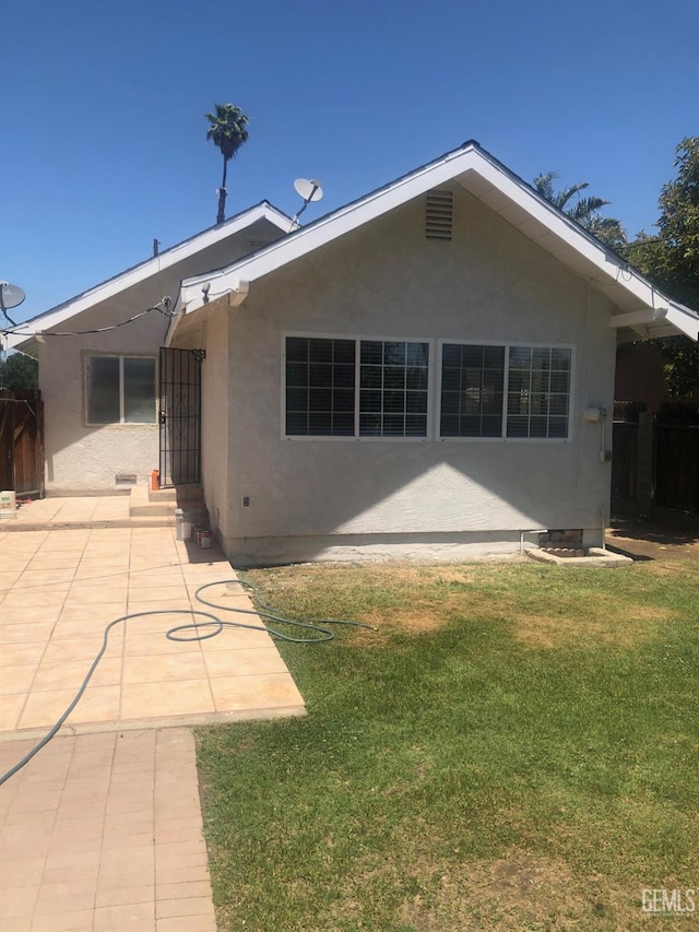 1543 Sycamore Dr, Wasco, CA 93280 - back of property featuring stucco siding, a patio area, and entry steps