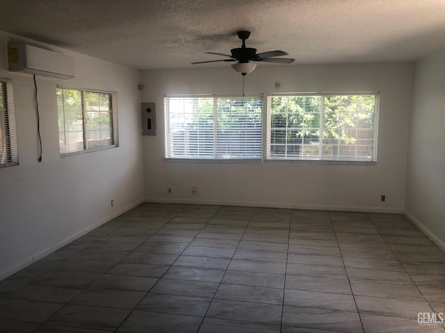 1543 Sycamore Dr, Wasco, CA 93280 - empty room featuring a wall mounted AC, electric panel, ceiling fan, a textured ceiling, and tile patterned flooring