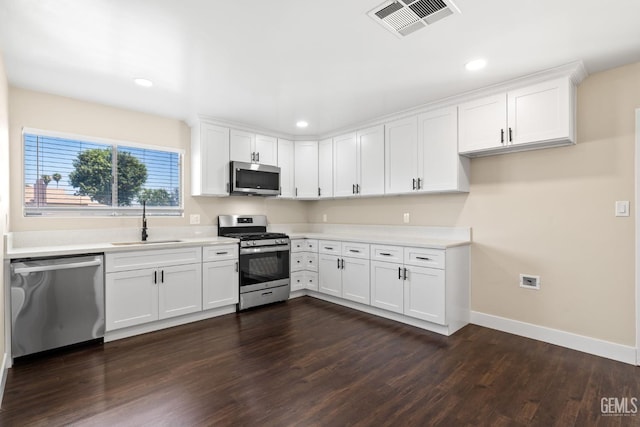 2605 Bladen St, Bakersfield, CA 93309 - kitchen featuring stainless steel appliances, dark wood finished floors, white cabinetry, light countertops, and recessed lighting