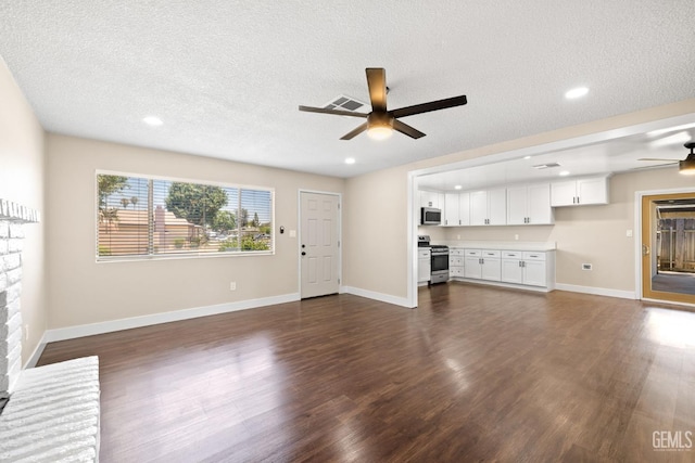 2605 Bladen St, Bakersfield, CA 93309 - unfurnished living room with ceiling fan, dark wood-style flooring, a textured ceiling, recessed lighting, and a fireplace