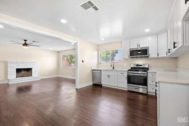 2605 Bladen St, Bakersfield, CA 93309 - kitchen featuring appliances with stainless steel finishes, a ceiling fan, light countertops, dark wood-style floors, and white cabinetry