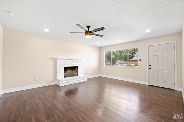 2605 Bladen St, Bakersfield, CA 93309 - unfurnished living room with a ceiling fan, dark wood-type flooring, a fireplace, recessed lighting, and a textured ceiling