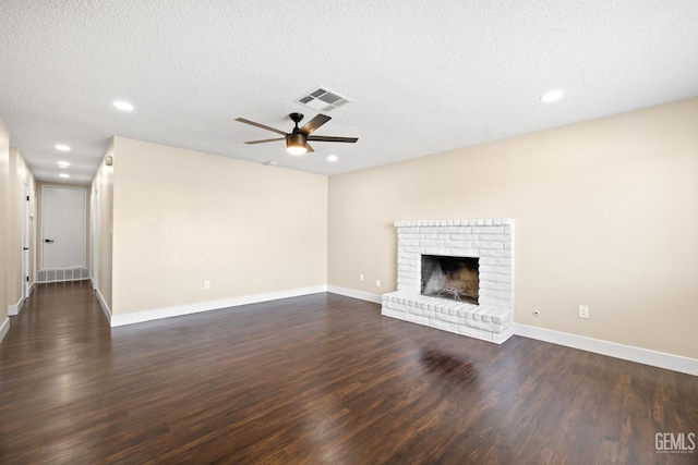2605 Bladen St, Bakersfield, CA 93309 - unfurnished living room with a ceiling fan, dark wood-type flooring, a fireplace, recessed lighting, and a textured ceiling