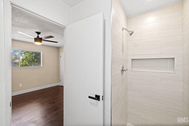 2605 Bladen St, Bakersfield, CA 93309 - bathroom with tiled shower, a ceiling fan, wood finished floors, and a textured ceiling