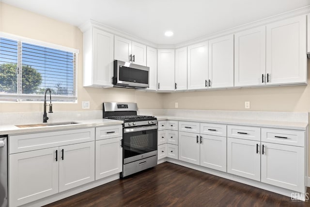 2605 Bladen St, Bakersfield, CA 93309 - kitchen featuring appliances with stainless steel finishes, white cabinetry, dark wood-type flooring, light countertops, and recessed lighting
