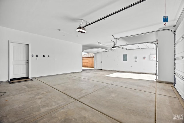 garage with electric panel and a garage door opener