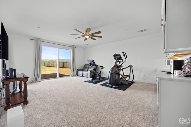 workout area with light colored carpet and ceiling fan