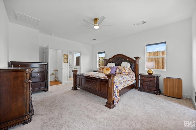 carpeted bedroom featuring ensuite bath and ceiling fan