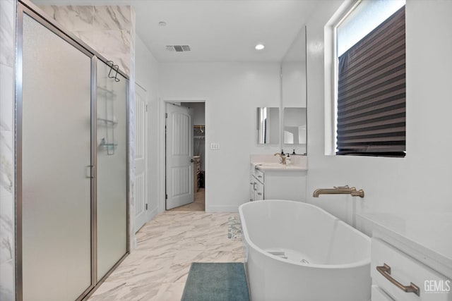 bathroom featuring shower with separate bathtub and vanity