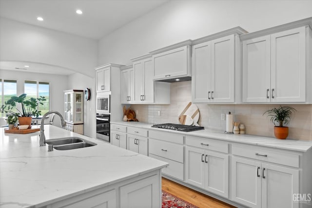 kitchen with sink, white cabinets, and stainless steel appliances