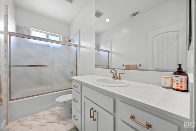 full bathroom featuring vanity, enclosed tub / shower combo, and toilet