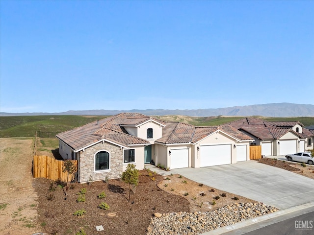 view of front of property featuring a mountain view and a garage