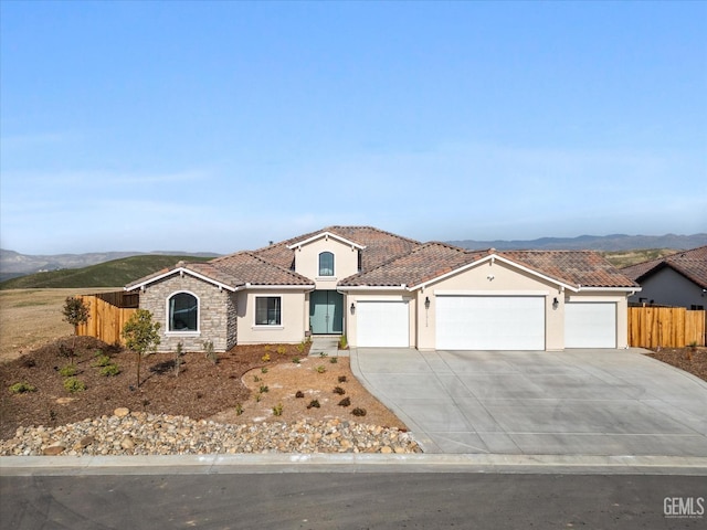 view of front of home with a mountain view and a garage