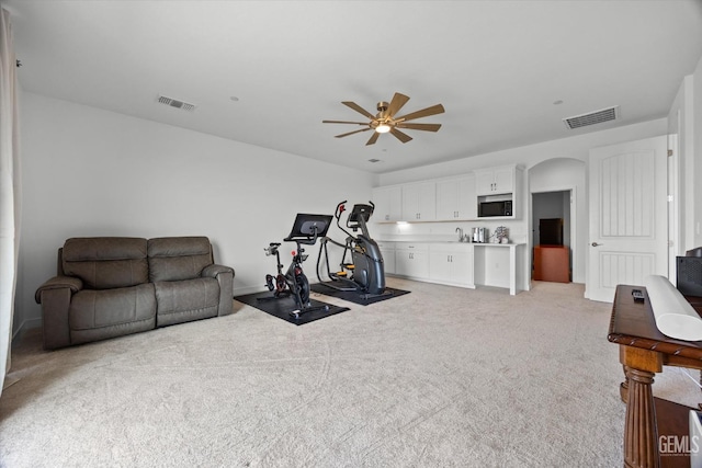 workout area with carpet flooring and ceiling fan