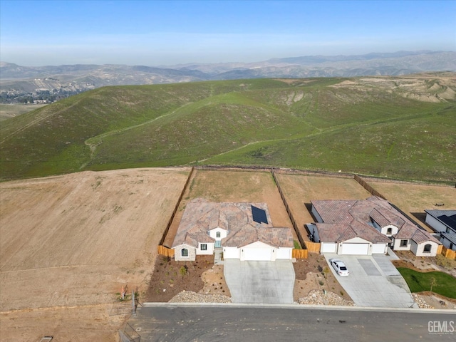 drone / aerial view with a mountain view and a rural view