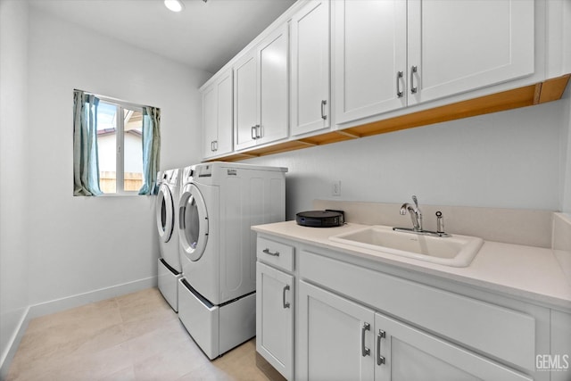 laundry area with cabinets, sink, light tile patterned floors, and washer and dryer