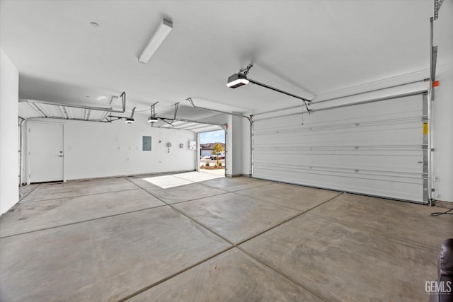 garage featuring electric panel and a garage door opener