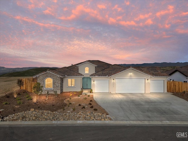 view of front of property featuring a mountain view and a garage