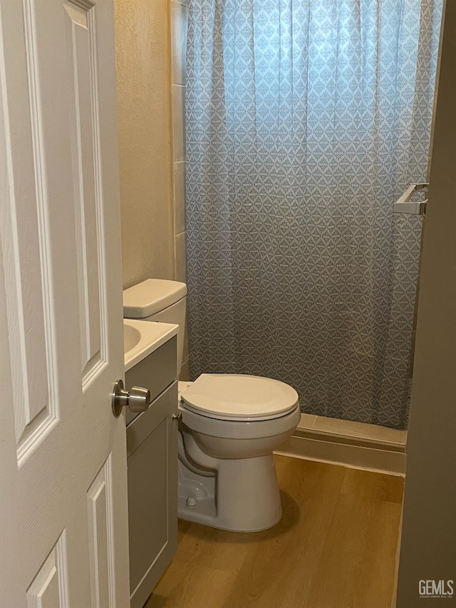 214 Buchanan St, Taft, CA 93268 - full bath with wood finished floors, toilet, vanity, and a shower with curtain