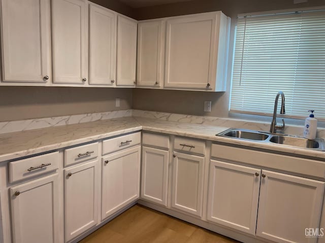 214 Buchanan St, Taft, CA 93268 - kitchen with a sink, white cabinetry, and light wood-style flooring