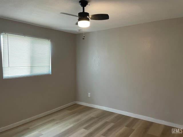 214 Buchanan St, Taft, CA 93268 - spare room featuring light wood-style floors, a ceiling fan, and baseboards