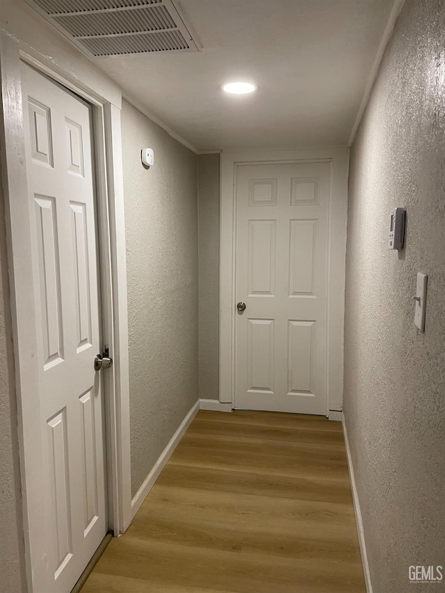 214 Buchanan St, Taft, CA 93268 - corridor with a textured wall, light wood finished floors, baseboards, and recessed lighting