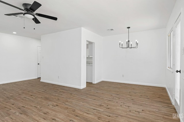 1920 Doolittle Ave, Bakersfield, CA 93304 - empty room featuring a chandelier, wood finished floors, a ceiling fan, baseboards, and recessed lighting