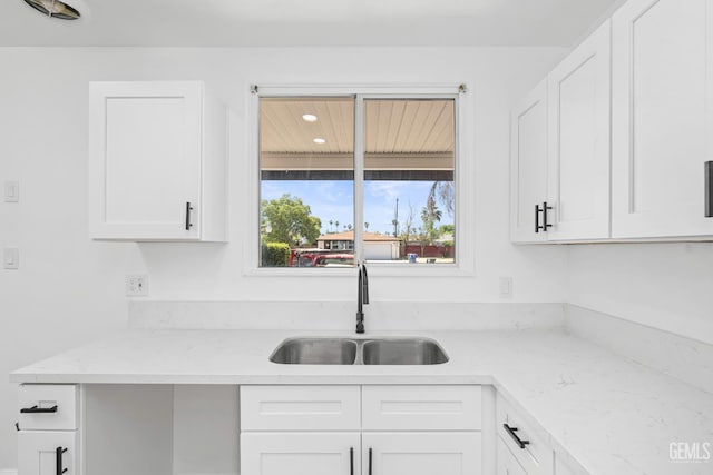 1920 Doolittle Ave, Bakersfield, CA 93304 - kitchen featuring a sink, white cabinets, light stone counters, and recessed lighting