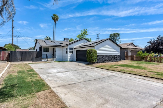 1920 Doolittle Ave, Bakersfield, CA 93304 - ranch-style house with concrete driveway, solar panels, and an attached garage