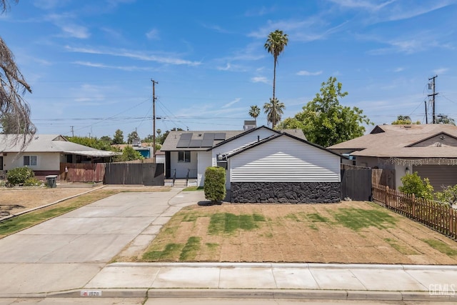 1920 Doolittle Ave, Bakersfield, CA 93304 - bungalow-style home featuring roof mounted solar panels, concrete driveway, and a residential view