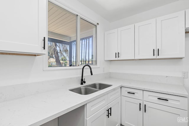 1920 Doolittle Ave, Bakersfield, CA 93304 - kitchen with a sink, white cabinetry, and light stone counters