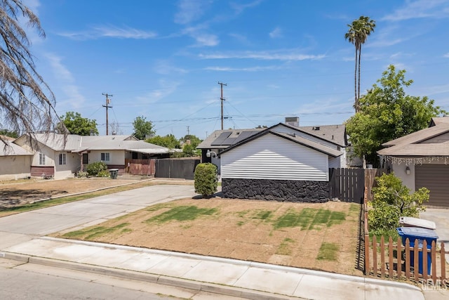 1920 Doolittle Ave, Bakersfield, CA 93304 - view of front of property with roof mounted solar panels and concrete driveway