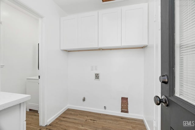 1920 Doolittle Ave, Bakersfield, CA 93304 - laundry area with washer hookup, cabinet space, wood finished floors, and baseboards