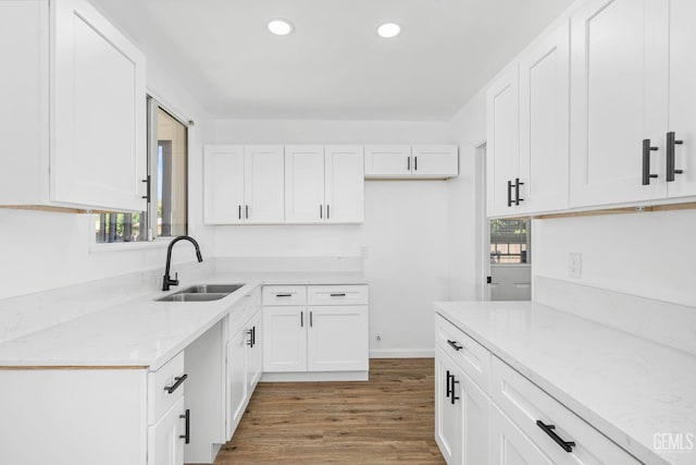 1920 Doolittle Ave, Bakersfield, CA 93304 - kitchen featuring a sink, wood finished floors, white cabinets, recessed lighting, and light stone countertops
