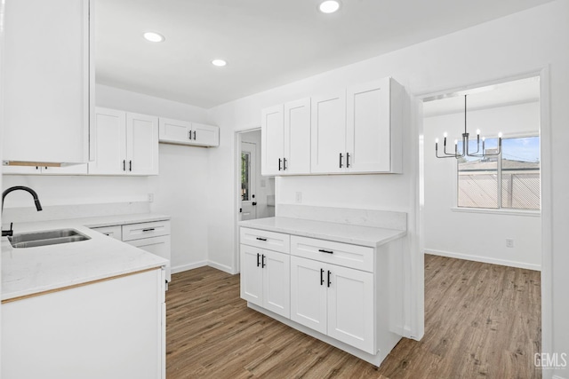 1920 Doolittle Ave, Bakersfield, CA 93304 - kitchen featuring a sink, light wood finished floors, white cabinetry, baseboards, and recessed lighting