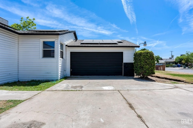 1920 Doolittle Ave, Bakersfield, CA 93304 - view of home's exterior with concrete driveway, solar panels, and an attached garage