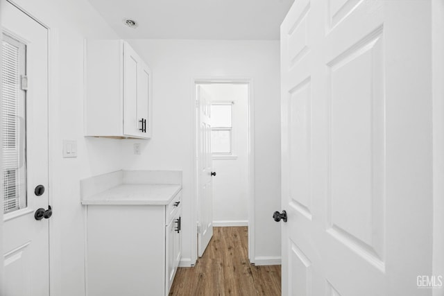 1920 Doolittle Ave, Bakersfield, CA 93304 - laundry area with light wood-style floors and baseboards