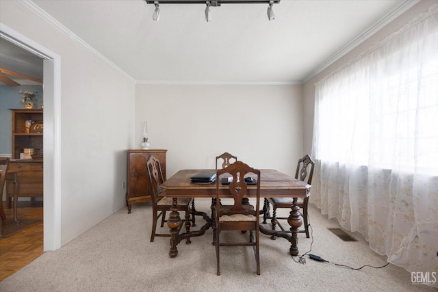 dining room featuring crown molding