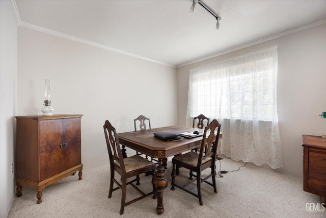dining space featuring light colored carpet and crown molding