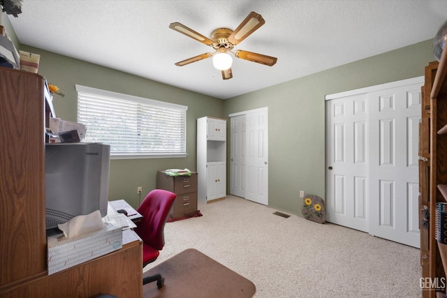 home office featuring ceiling fan and carpet floors
